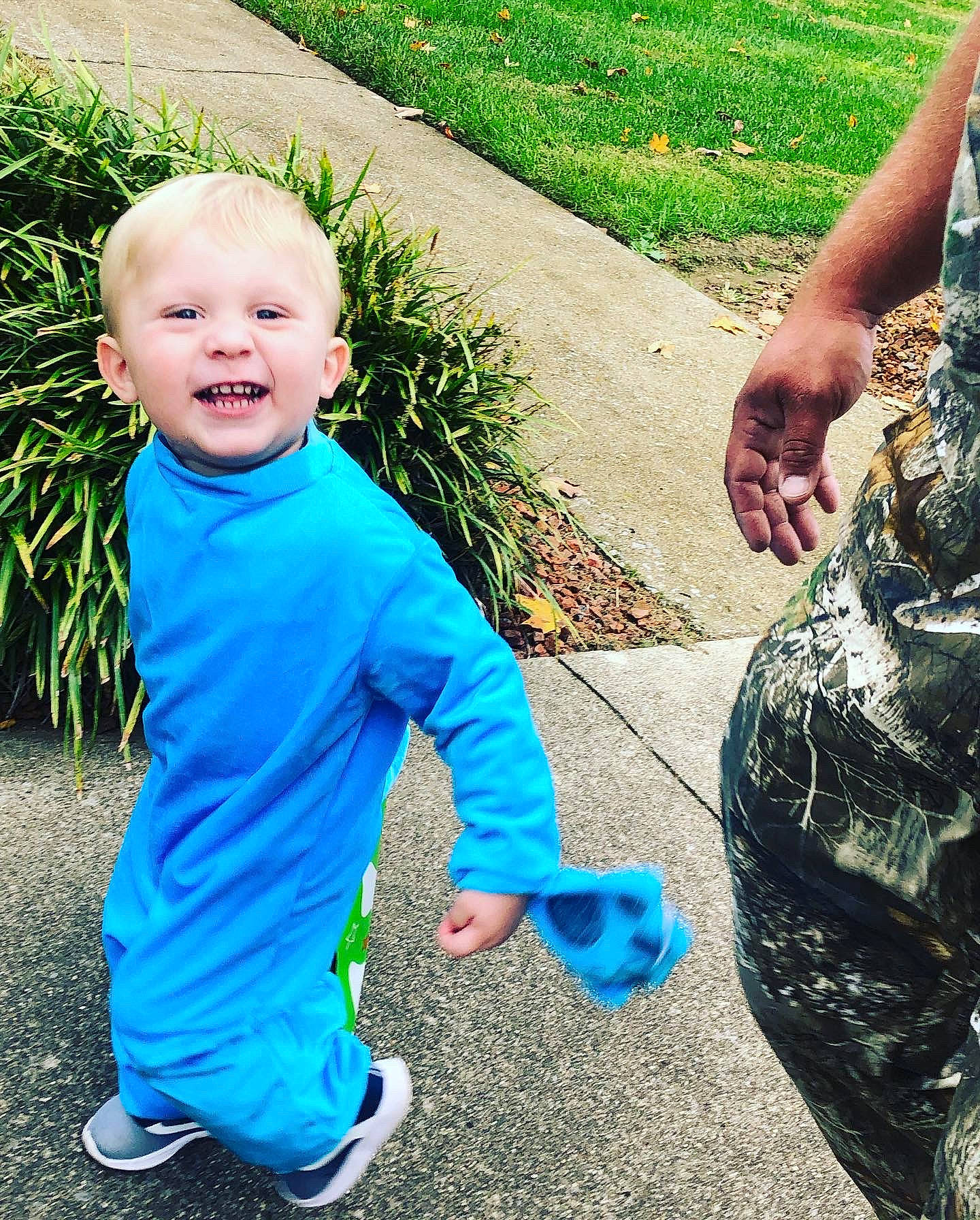 Huntley is registered to the contest to win money with this photo: baby_toddler_clothing, blue, community, cool, fun, gesture, grass, hairstyle, happy, human, leaf, leg, leisure, mammal, morning, people_in_nature, person, plant, public_space, smile