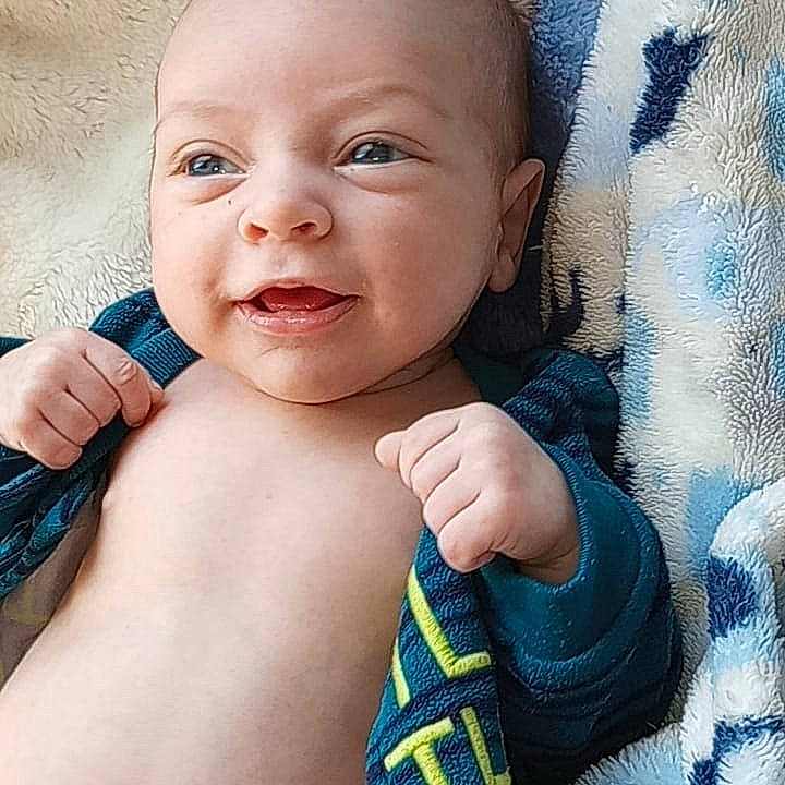 Weston Hank is registered to the contest to win money with this photo: arm, azure, baby, baby_toddler_clothing, cheek, chin, eyebrow, eyelash, face, facial_expression, finger, hand, human_body, lip, mouth, neck, nose, person, product, skin
