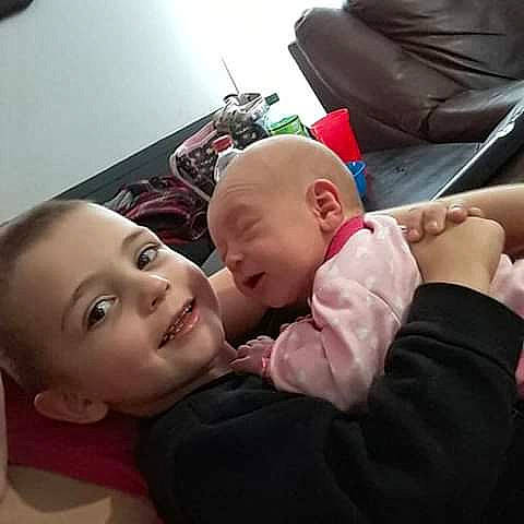 Waylon And Willie is registered to the contest to win money with this photo: arm, cheek, child, day, ear, finger, girl, head, infant, mother, mouth, person, product, toddler