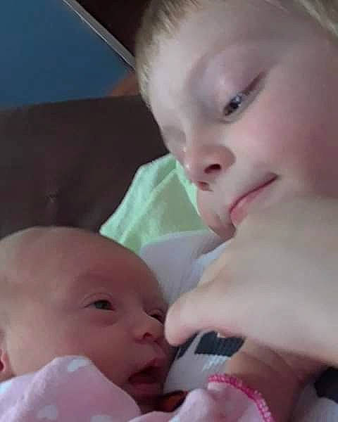 Waylon And Willie is registered to the contest to win money with this photo: cheek, child, chin, close_up, eye, eyebrow, face, finger, forehead, girl, hand, head, human_hair_color, infant, lip, mother, mouth, nose, person, skin