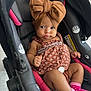 baby, car_seat, headwrap, bow, dress, pink_socks, infant, child, seat_belt, patterned_clothing, cute, indoor, portrait, person, small_child, hands, legs, footwear, expression, closeup