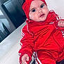 Alba a rejoint le concours — aidez-le/la à gagner de superbes lots ! baby, child, red_clothing, headband, tracksuit, indoor, couch, white_couch, baby_hand, baby_face, portrait, cute, chubby_cheeks, relaxed, infant, fashion, child_fashion, person, home_interior, seated