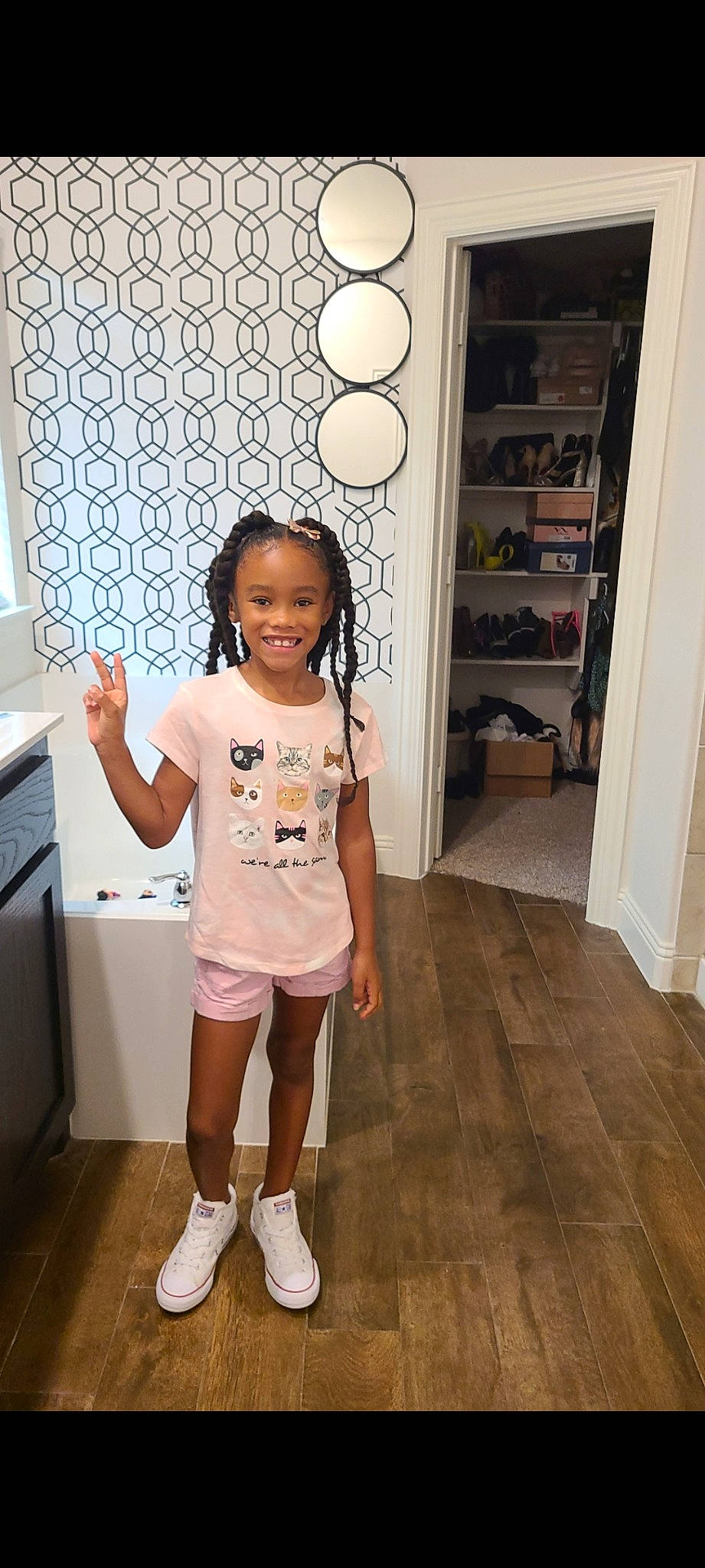 August is registered to the contest to win money with this photo: baby_toddler_clothing, door, floor, flooring, happy, hardwood, home_appliance, human_leg, joy, leg, person, room, shelf, shorts, sleeve, smile, standing, t_shirt, thigh, toddler