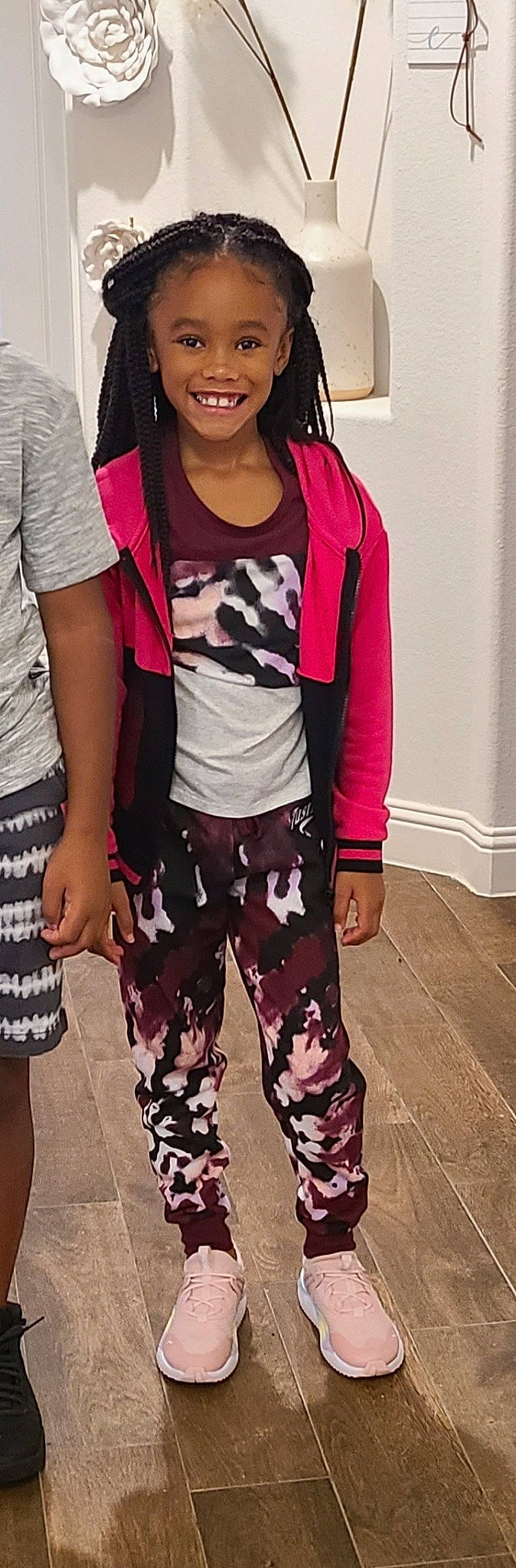 August is registered to the contest to win money with this photo: active_pants, black_hair, clothing, cool, eyewear, fashion_design, gesture, hairstyle, joint, joy, knee, magenta, neck, person, pink, shoulder, sleeve, standing, t_shirt, textile