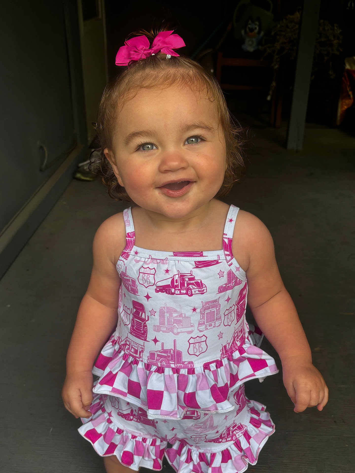 Avangeline joined the competition — help win amazing prizes! bright_eyes, casual, child, curly_hair, cute, dress, face, happy, innocent, outdoor, patterned_clothing, person, pink_bow, playful, porch, smiling, standing, summer_clothing, toddler, young_child
