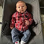 baby, baby_rocker, blue_pants, casual_clothing, child, comfortable, curious_expression, cute, floor_tiles, heart_pattern, indoor, infant, looking_at_camera, person, plaid_shirt, seat, seated, toddler, white_socks, young_child