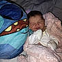 Trinity is registered to the contest to win money with this photo: newborn, baby, blanket, plush, pillow, sleeping, cute, soft, infant, cozy, bed, comfort, child, cartoon, smile, stuffed_toy, white_clothing, indoor, rest, peaceful