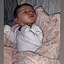 Trinity is registered to the contest to win money with this photo: newborn, baby, blanket, pink_blanket, white_clothing, sleeping, face, infant, soft_texture, bed, resting, cute, small_hands, lying_down, indoors, person, young_child, cozy, portrait, sleepwear