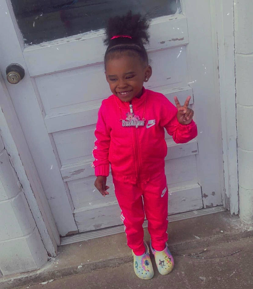 Brooklynn is registered to the contest to win money with this photo: active_pants, baby_toddler_clothing, child, door, happy, hat, human_body, joy, magenta, person, pink, purple, shoe, sleeve, smile, sneakers, standing, street_fashion, sweatpant, tints_and_shades