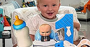 Apolo joined the competition — help win amazing prizes! toddler, child, baby, smiling, birthday, birthday_cake, high_chair, toy, doll, baby_bottle, money, party, indoors, living_room, furniture, portrait, blond_hair, blue_shirt, celebration, wrapping_paper