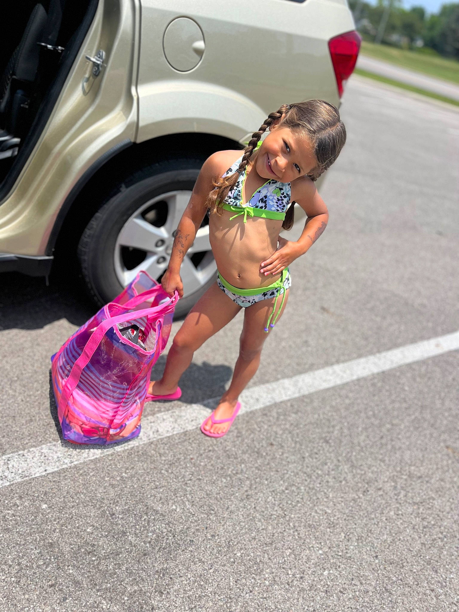 Zaniyah is registered to the contest to win money with this photo: alloy_wheel, asphalt, automotive_design, automotive_exterior, automotive_lighting, automotive_tire, automotive_wheel_system, bumper, car, eyewear, fender, hood, human_leg, joy, motor_vehicle, person, rim, shorts, thigh, tire