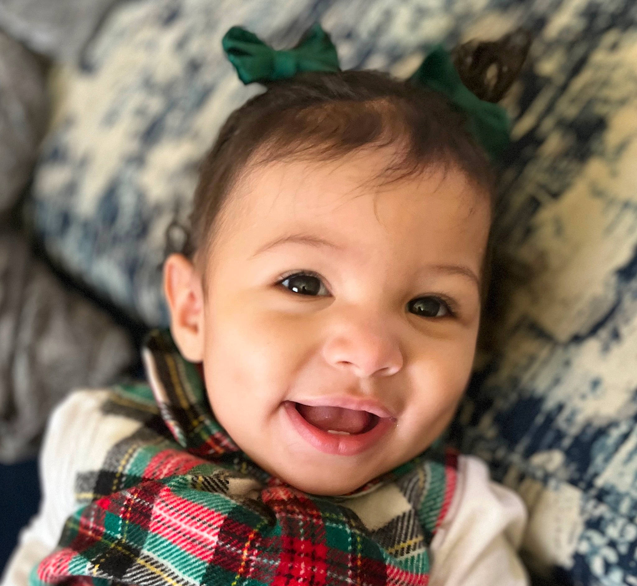 Azara is registered to the contest to win money with this photo: cheek, chin, ear, eye, eyelash, face, gesture, green, happy, head, iris, lip, mouth, nose, person, skin, sleeve, smile, tartan, textile