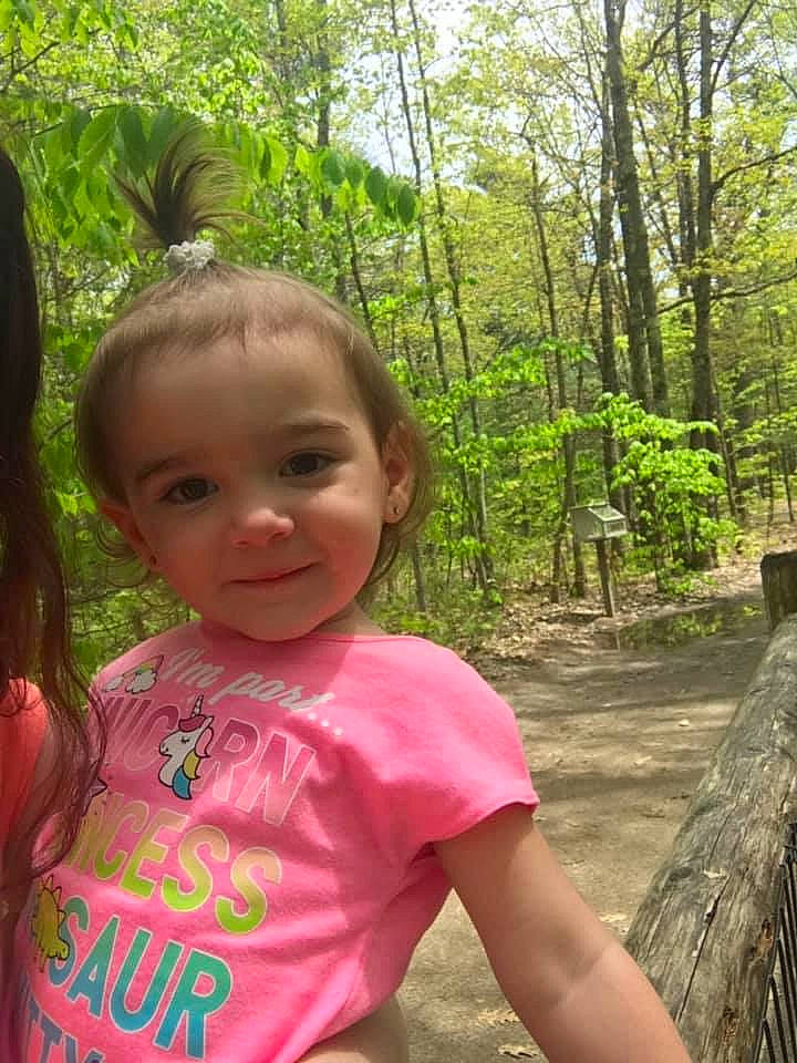 Whitlee is registered to the contest to win money with this photo: adaptation, child, fawn, forest, fun, grass, happy, jungle, leisure, person, pink, plant, play, recreation, smile, summer, terrestrial_plant, toddler, tree, vacation