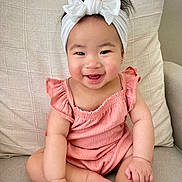 Lyla joined the competition — help win amazing prizes! accessories, baby, babylaughing, couch, cushion, face, furniture, happy, head, headband, homedecor, jewelry, laughing, necklace, person, photography, portrait, sitting, smile