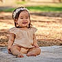 baby, child, smiling, sitting, blanket, headband, outdoor, nature, grass, sunlight, happy, cute, portrait, infant, clothing, feet, skin, face, young, flower