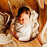 antler, antlers, baby, blanket, bowl, closed_eyes, cotton, face, floor, hair, infant, metal, newborn, photography, portrait, rustic, sleeping, swaddled, warm_lighting, wood