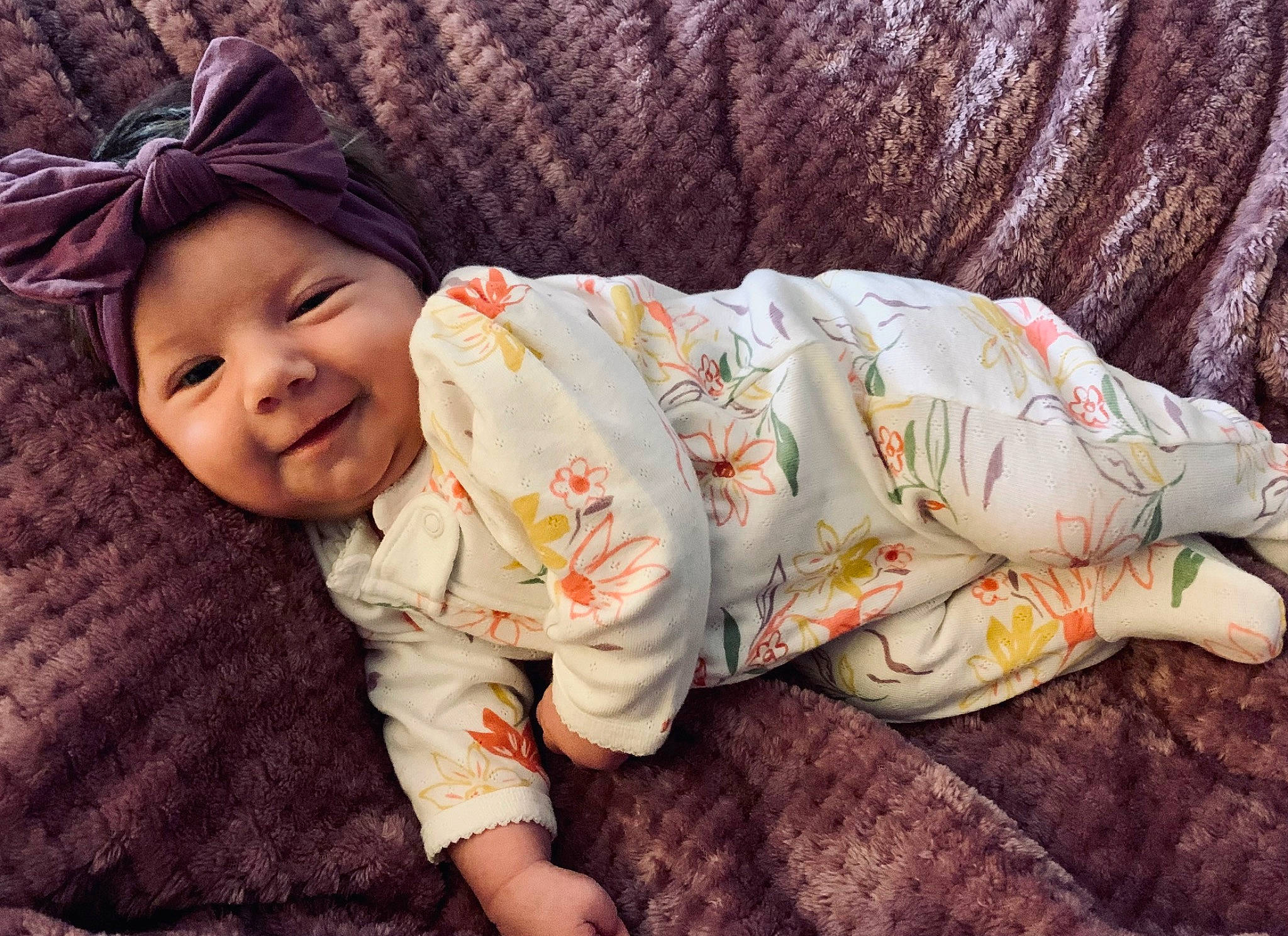 Olivia is registered to the contest to win money with this photo: baby, baby_toddler_clothing, cap, child, comfort, eye, foot, grass, happy, hat, head, headwear, human_body, leaf, linens, person, sitting, skin, sleeve, smile