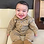 Jayden Winstersheim a rejoint le concours — aidez-le/la à gagner de superbes lots ! baby, smiling, child, infant, sitting, couch, clothing, footwear, happy, portrait, indoors, cute, young_child, face, person, buttoned_shirt, short_hair, seated, warm_clothing, leather_shoes