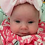 baby, infant, pink_bow, headband, pink_clothing, floral_pattern, pacifier_clip, face, skin, cute, adorable, child, portrait, closeup, young, smiling, indoors, person, baby_girl, expression
