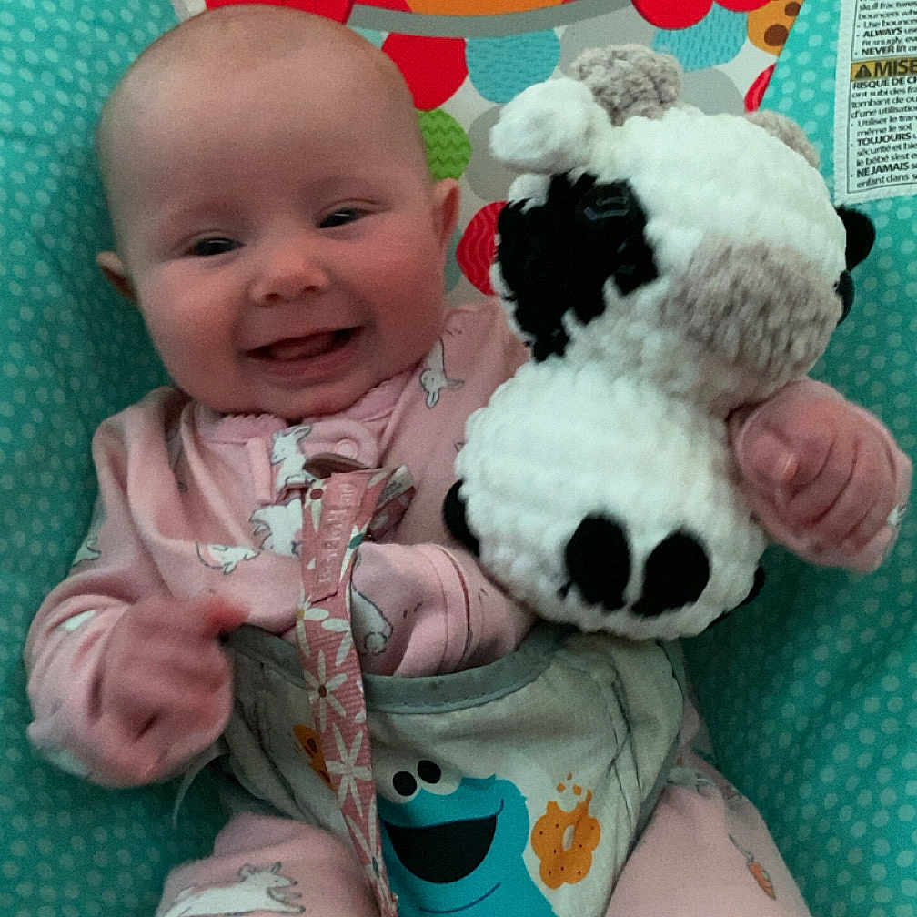 Jade is registered to the contest to win money with this photo: baby, baby_seat, bunny_print, child, clothing, colorful, cute, elmo, face, happy, indoor, infant, pajamas, person, playful, seat, smiling, soft_toy, stuffed_animal, toy