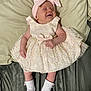 Jade joined the competition — help win amazing prizes! baby, infant, smiling, dress, lace, bow, headband, white_socks, cushion, blanket, soft_fabric, sleeping, happy, cute, child, person, indoors, portrait, newborn, resting