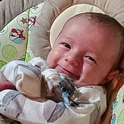 Raylan joined the competition — help win amazing prizes! baby, infant, smile, pajamas, face, cushion, pattern, cartoon, seated, cozy, child, cute, indoor, closeup, happy, young, person, playful, soft, comfort