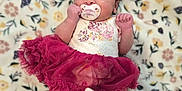 Nariah Alaia Rene' is registered to the contest to win money with this photo: adorable, baby, blanket, booties, child, cute, dress, floral_pattern, headband, indoors, infant, lying_down, newborn, pacifier, peaceful, portrait, skirt, sleeping, small_hands, soft_texture