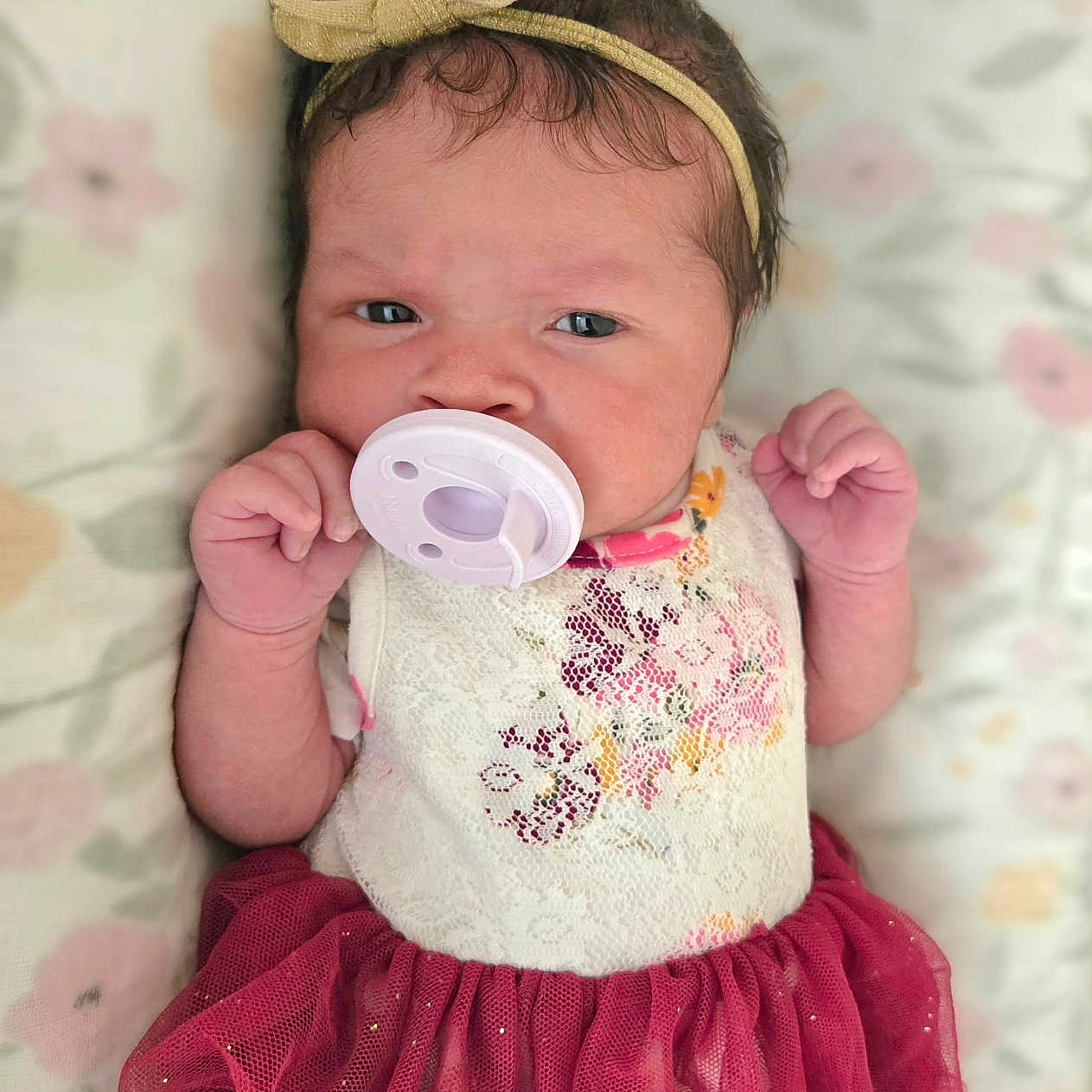 Nariah Alaia Rene' joined the competition — help win amazing prizes! baby, blanket, bow, child, clothing, cute, dress, expression, face, floral_pattern, hand, headband, indoors, infant, lying_down, newborn, pacifier, portrait, soft, tulle_skirt