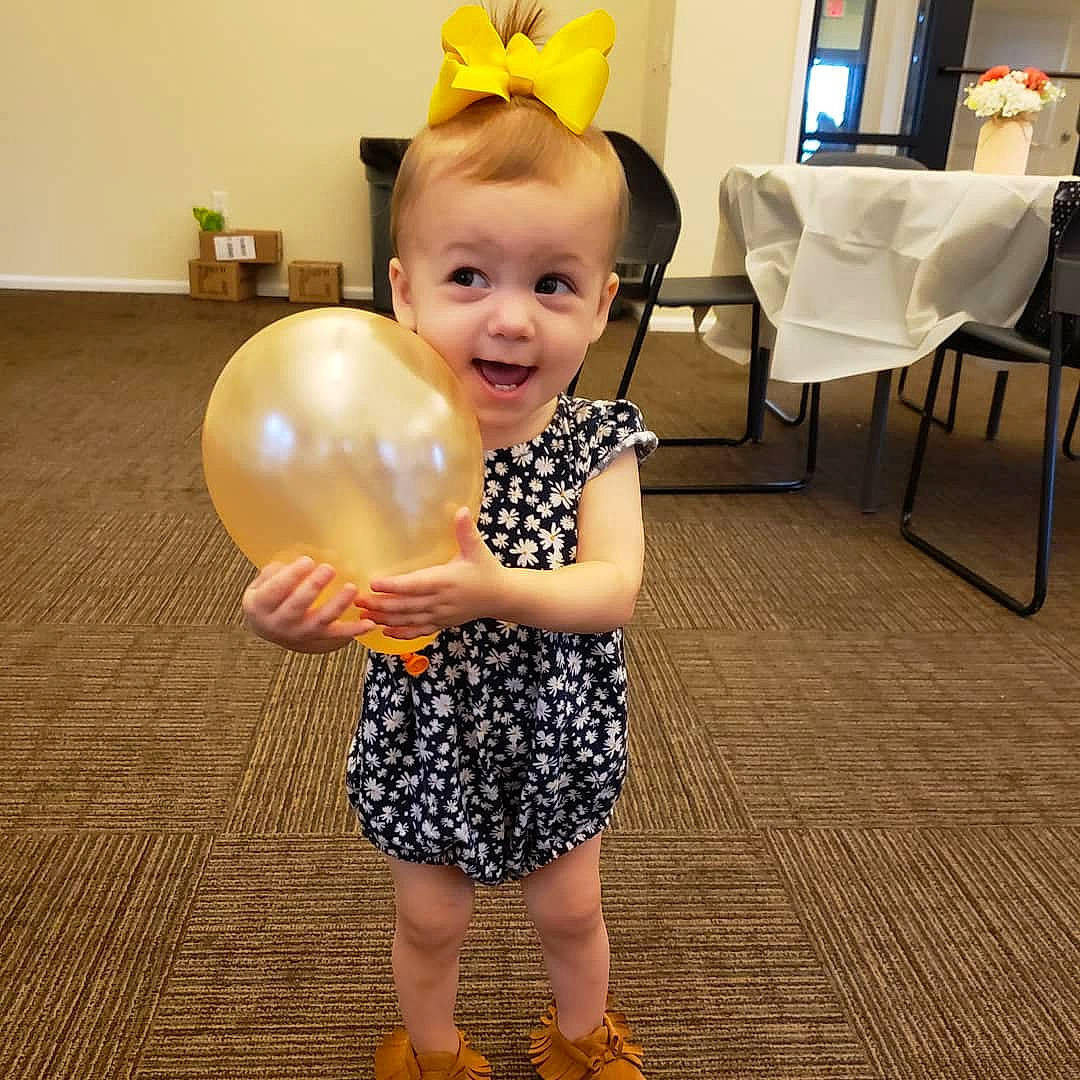 Josephine joined the competition — help win amazing prizes! balloon, child, costume, design, dress, floor, flooring, happy, outerwear, party, party_supply, pattern, person, smile, toddler, yellow