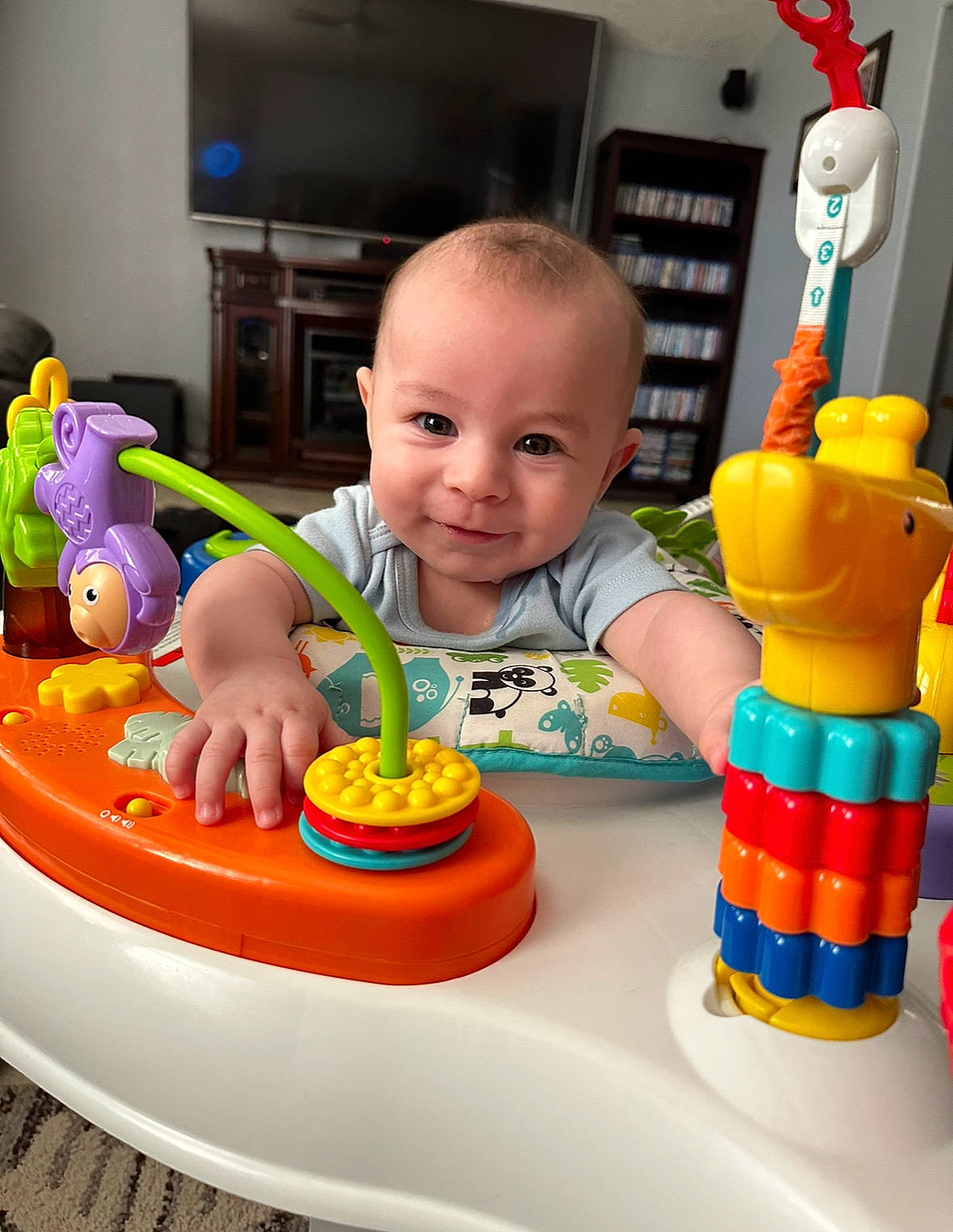Raylan is registered to the contest to win money with this photo: baby, baby_playing_with_toys, baby_products, baby_toys, child, event, fun, leisure, orange, party, person, picture_frame, plastic, play, recreation, room, sitting, smile, toddler, toy