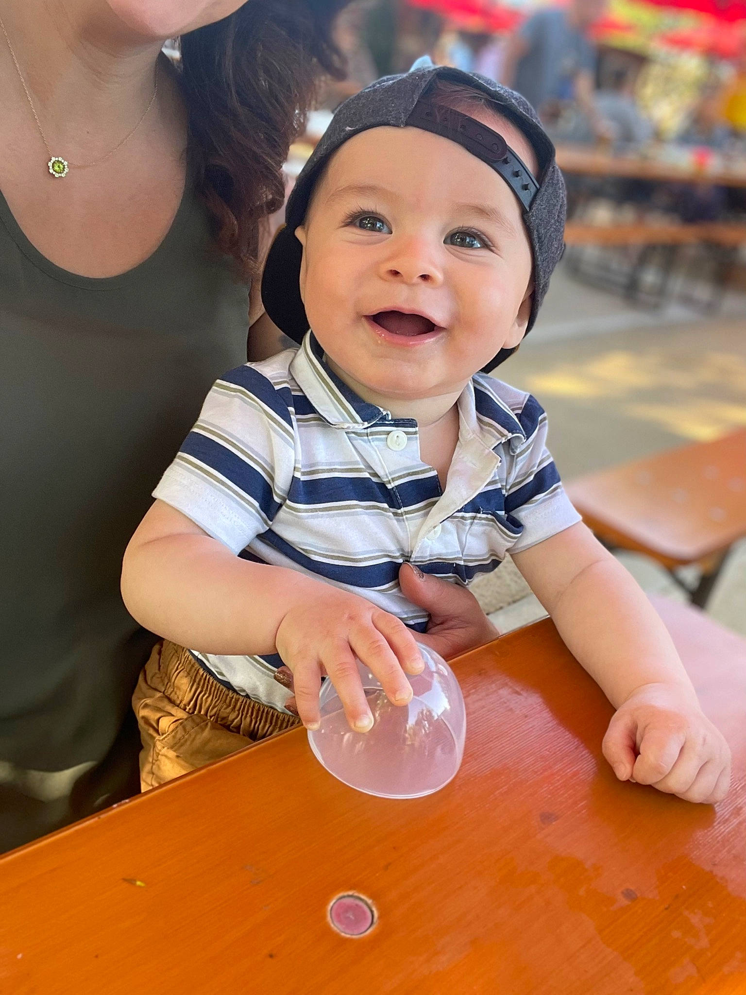 Raylan is registered to the contest to win money with this photo: baby, chair, child, flooring, fun, glass, happy, headwear, jewellery, joy, leisure, person, play, recreation, sitting, smile, summer, t_shirt, table, tableware