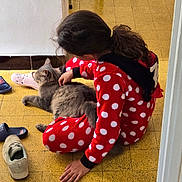 Tonky participe au concours pour gagner de l'argent avec cette photo : animal, casual, cat, child, childhood, comfort, companion, cozy, floor_tiles, gray_cat, hair_tied, home, indoor, pajamas, petting, quiet_moment, red_polka_dot, relaxing, shoes, yellow_floor