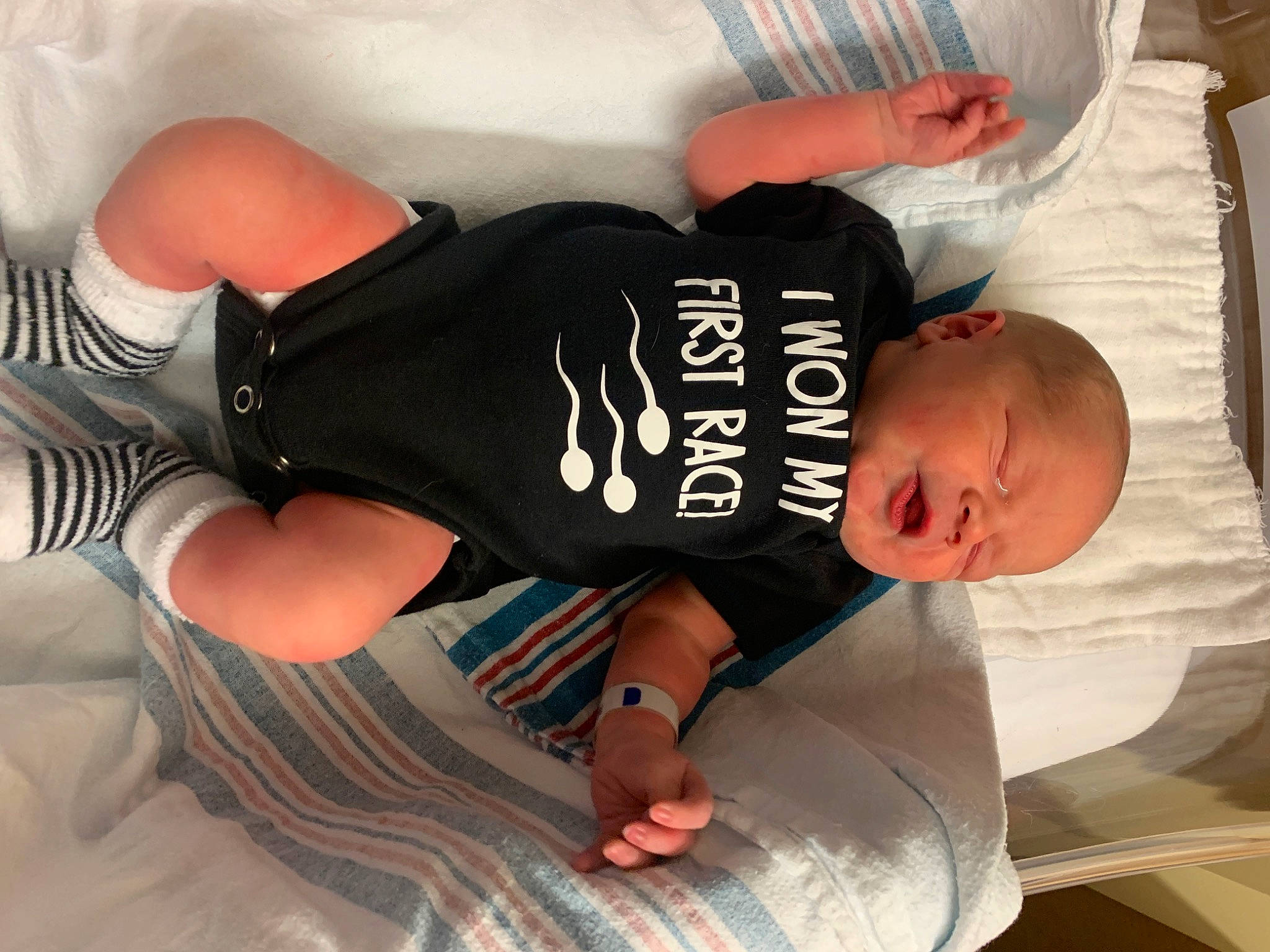 Caspian is registered to the contest to win money with this photo: baby_toddler_clothing, chest, comfort, elbow, finger, foot, gesture, hand, human_body, human_leg, joint, knee, person, sleeve, sportswear, t_shirt, thigh, thumb, toddler, waist