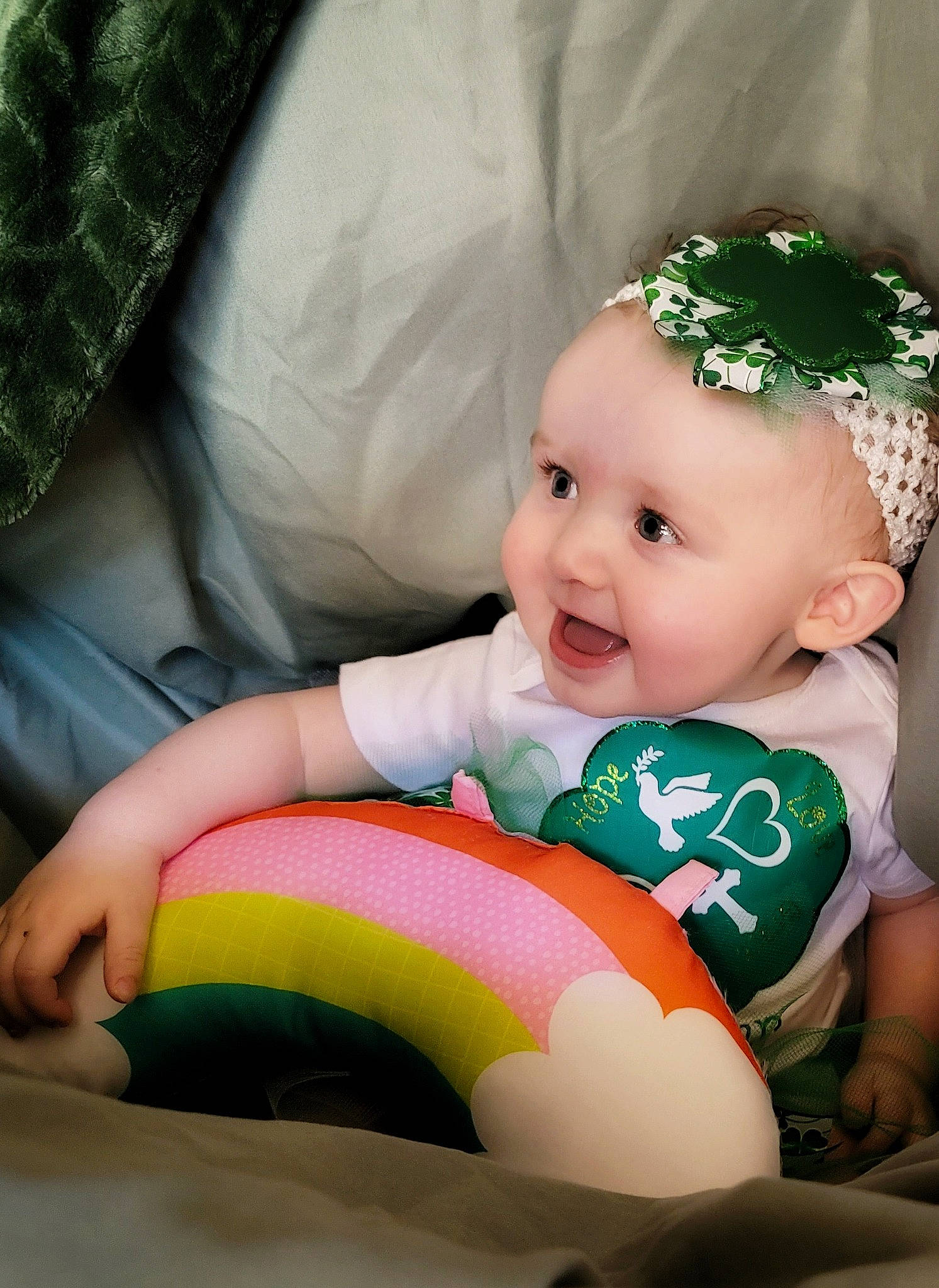Stella is registered to the contest to win money with this photo: baby, baby_playing_with_toys, baby_products, baby_toddler_clothing, child, comfort, eye, fun, grass, green, happy, head, headwear, human_body, human_leg, person, sitting, smile, sock, textile