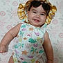 baby, smiling, hat, sun_hat, swimsuit, colorful_clothing, lying_down, floral_pattern, blanket, infant, child, cute, happy, face, cheeks, skin, indoors, one_person, portrait, baby_girl