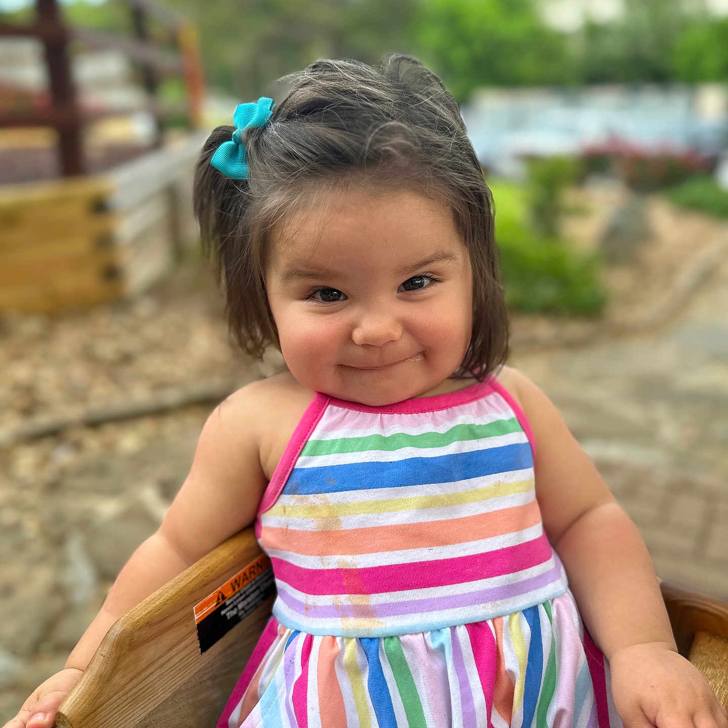 Scout joined the competition — help win amazing prizes! bodypart, child, clothing, dress, face, female, finger, furniture, girl, hand, happy, head, outdoors, person, photography, playarea, portrait, sitting, smile, wood