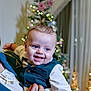 baby, child, smiling, blue_eyes, vest, bowtie, celebration, christmas_tree, holiday, indoor, person, happy, festive, lights, portrait, cute, dressed_up, holding, infant, background_blur