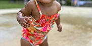 Maizie joined the competition — help win amazing prizes! child, toddler, smiling, swimsuit, wet, standing, outdoor, park, water, playful, happy, skin, face, hair, nature, daylight, person, summer, fun, background