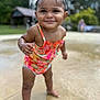 child, toddler, smiling, swimsuit, wet, standing, outdoor, park, water, playful, happy, skin, face, hair, nature, daylight, person, summer, fun, background