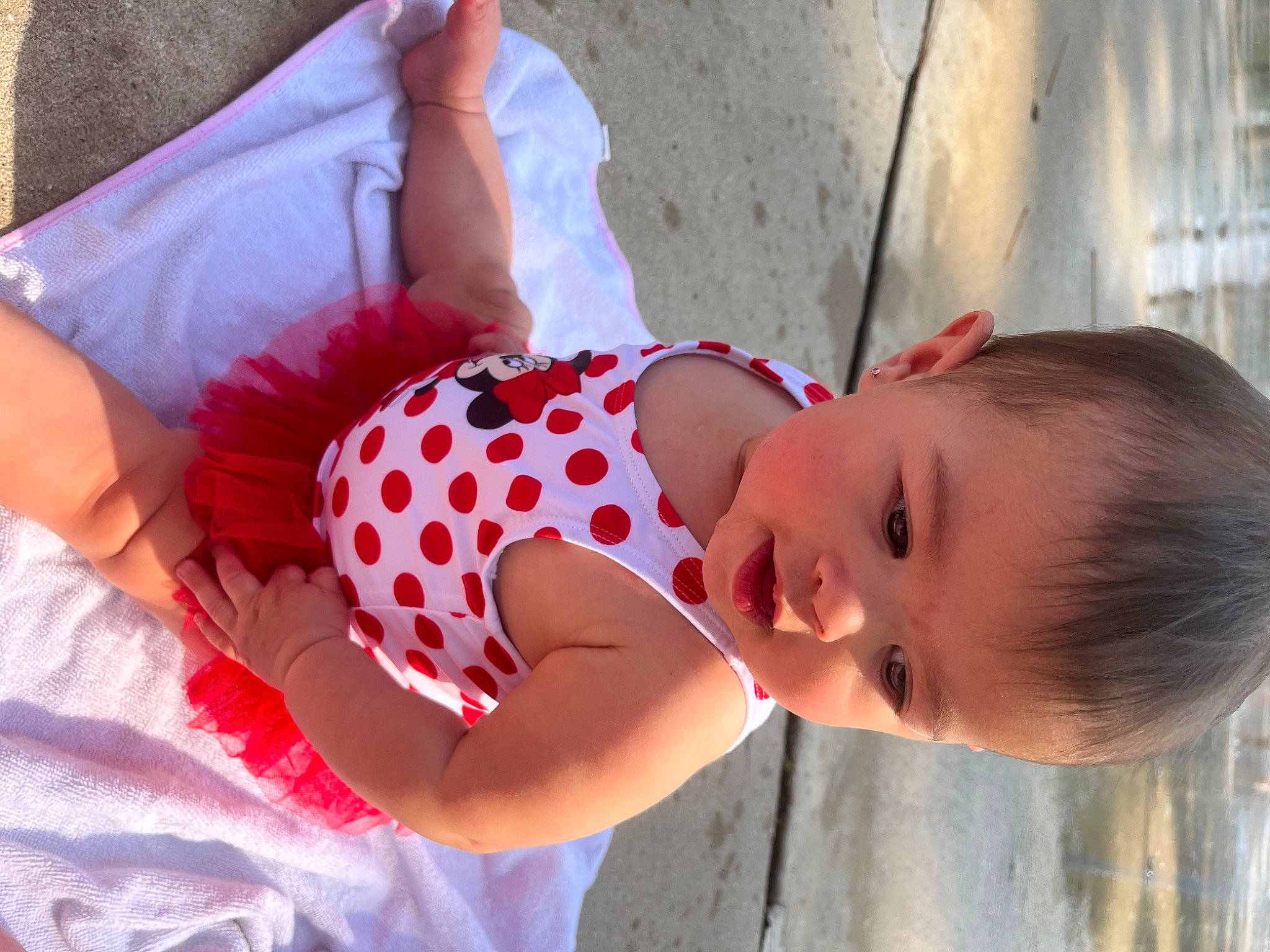 Claudia is registered to the contest to win money with this photo: abdomen, baby, baby_toddler_clothing, chest, child, elbow, fun, happy, human_leg, leisure, pattern, person, pink, plaid, sitting, smile, thigh, toddler, vacation, waist