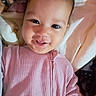 baby, infant, child, smiling, portrait, face, eyes, pink_clothing, onesie, bed, blanket, bedding, bedroom, indoor, happy, cute, lying_down, close_up, photography, cozy