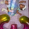 baby, balloons, blanket, booties, bow, celebration, dress, gold, headband, heart_balloons, indoors, infant, lying_down, newborn, pastel, photography, pink, portrait, ribbon, sleeping