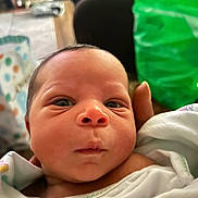 Cortez joined the competition — help win amazing prizes! newborn, baby, infant, closeup, face, eyes, blanket, hand, skin, portrait, indoors, curious, cute, sleepwear, head, small, human, person, soft, toddler