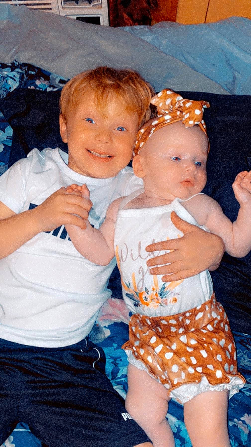 Dixi-rae is registered to the contest to win money with this photo: abdomen, baby, baby_toddler_clothing, blue, eye, facial_expression, finger, fun, gesture, happy, human_body, interaction, iris, joy, person, pink, shorts, skin, smile, standing