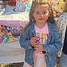 birthday_party, cake, celebration, child, clothing, cup, denim_jacket, face, food, girl, grass, happy, outdoor, party, pink, shoes, sunlight, table, tree, tutu
