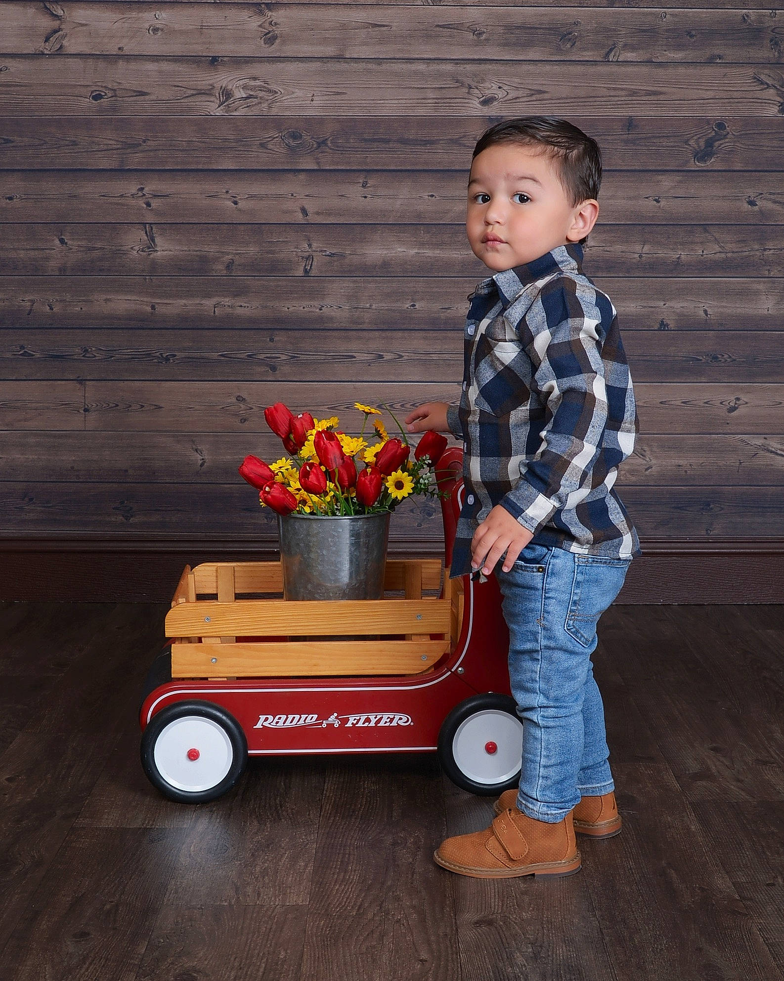 Cristiano is registered to the contest to win money with this photo: automotive_tire, automotive_wheel_system, child, denim, dress_shirt, flooring, flower, font, fun, happy, landscape, orange, person, plant, rolling, sitting, t_shirt, tire, toddler, wheel