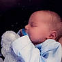 baby, sleeping, infant, soft_toy, stuffed_animal, blue_clothing, peaceful, child, portrait, close_up, cute, cozy, newborn, face, hand, background, indoor, toddler, resting, young