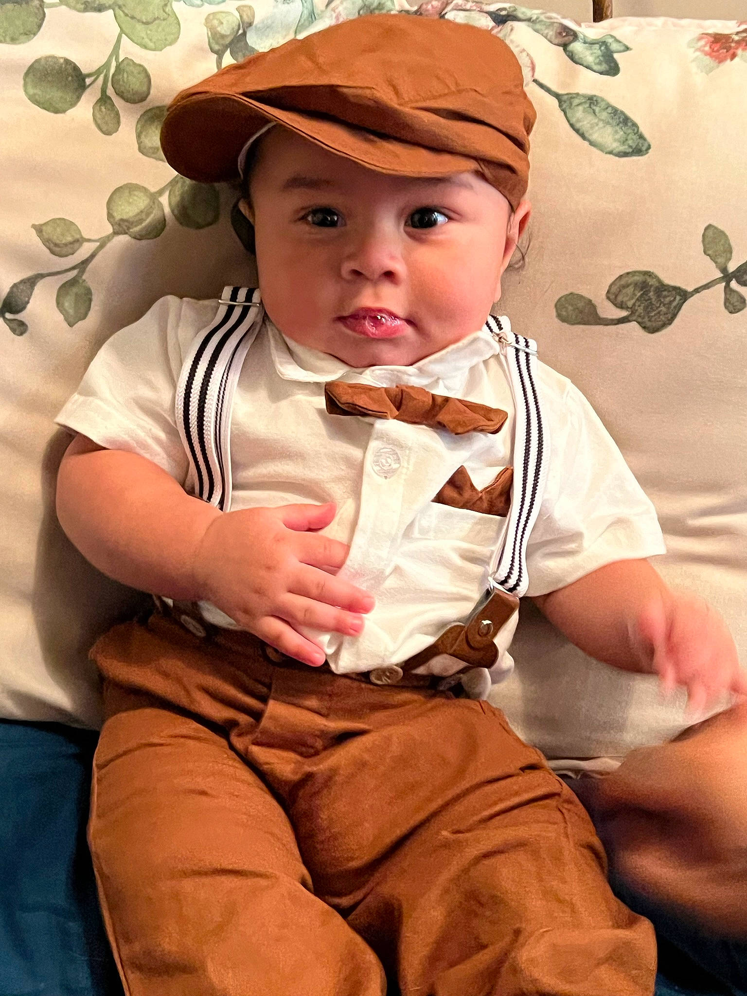 Jovanni is registered to the contest to win money with this photo: arm, baby, baby_toddler_clothing, cap, cheek, child, elbow, eye, face, finger, happy, hat, headgear, headwear, lip, person, sitting, skin, sleeve, sun_hat