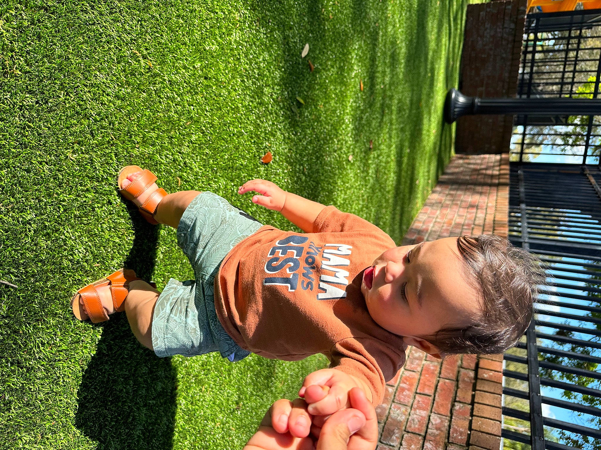 Jovanni joined the competition — help win amazing prizes! child, elbow, fun, grass, green, hand, happy, human_leg, knee, leaf, leisure, people_in_nature, person, plant, play, recreation, sitting, t_shirt, thigh, toddler