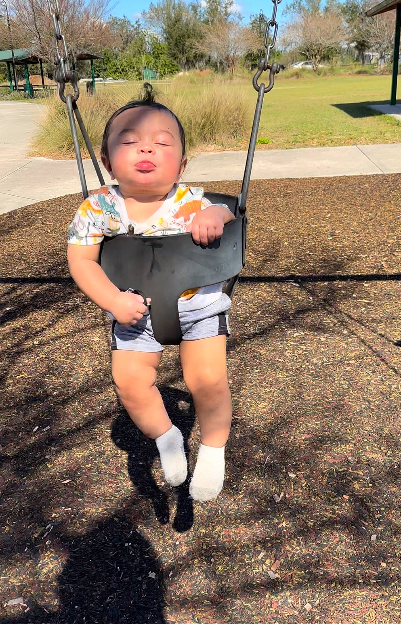 Jovanni joined the competition — help win amazing prizes! city, electric_blue, fun, grass, happy, landscape, leisure, outdoor_play_equipment, people_in_nature, person, plant, play, playground, public_space, recreation, sky, soil, swing, t_shirt, toddler